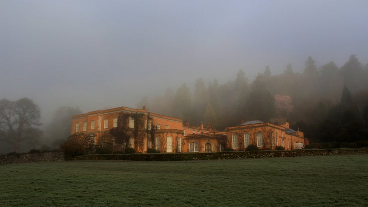 Morning winter mist surrounding the house at Killerton, Devon